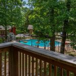 View of Foxfire Resort Cabins outdoor pool and surrounding wooded grounds from a at Foxfire Resort Cabins on Table Rock Lake